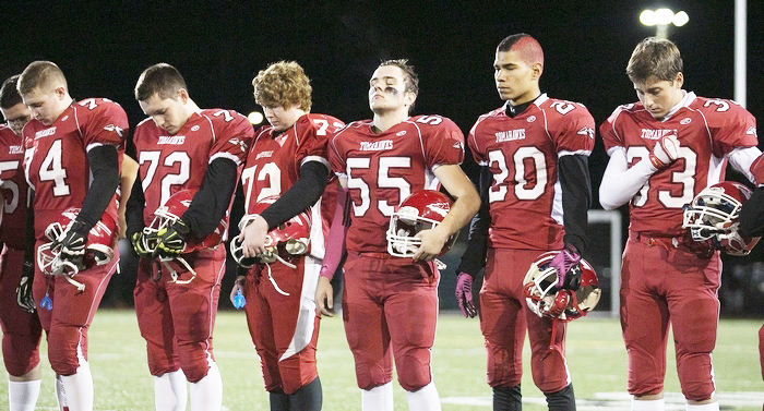 Marysville Pilchuck football players pause for a moment of reflection prior to the Wesco 3A championship game against Meadowdale on Friday night at Quil Ceda Stadium in Marysville. The (Everett) Herald