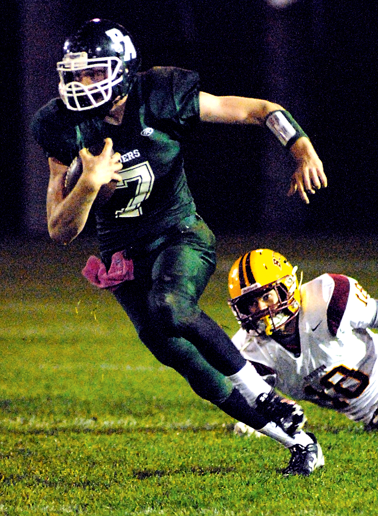 Port Angeles' Tyrus Beckett eludes the defense of Kingston's Tanner Draper in the second quarter of the Roughriders' 45-21 loss at Civic Field. Keith Thorpe/Peninsula Daily News