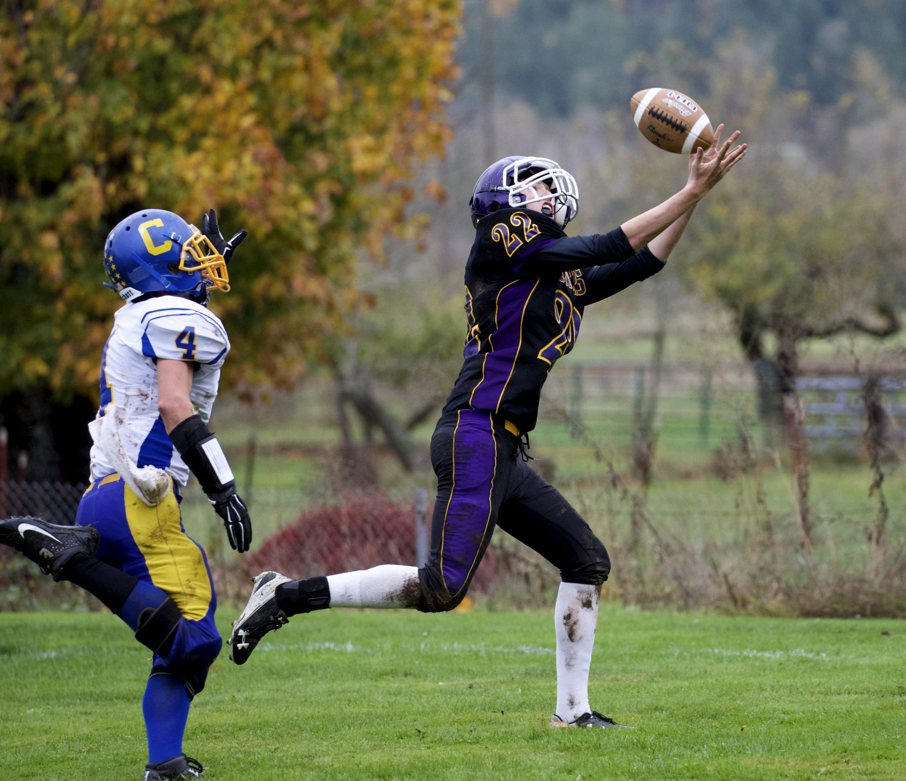 Quilcene's Jarod Smith beats out Crescent's Eric Emery (4) and hauls in a 22-yard touchdown pass during the Rangers 32-24 win in Quilcene on Saturday. Steve Mullensky/for Peninsula Daily News