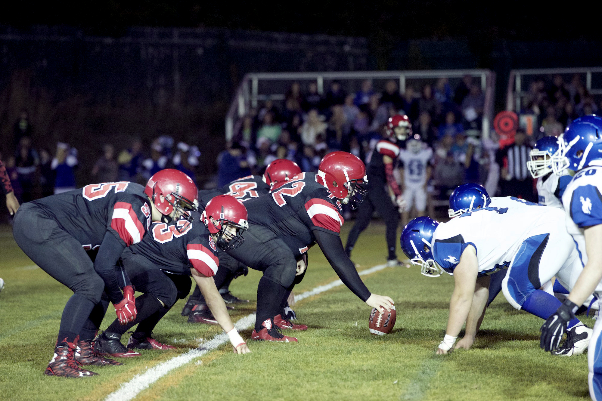 The Port Townsend offensive line awaits the snap of center Lucas Foster (with ball) before a play against Chimacum earlier this season. The Redhawks offensive line