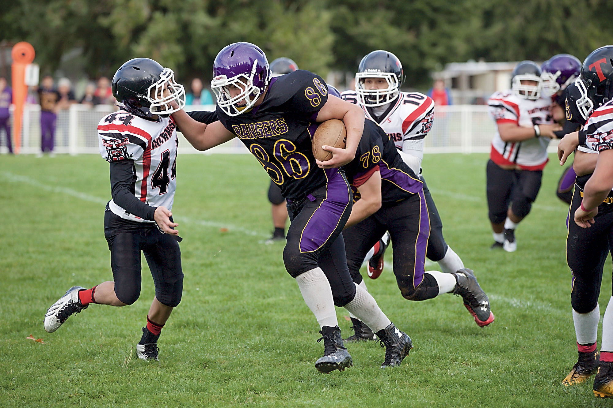 Quilcene's Triston Williams (86) charges through the Taholah defense en route to a first down during the Rangers' 86-28 win in the Quad-District playoffs. Steve Mullensky/for Peninsula Daily News