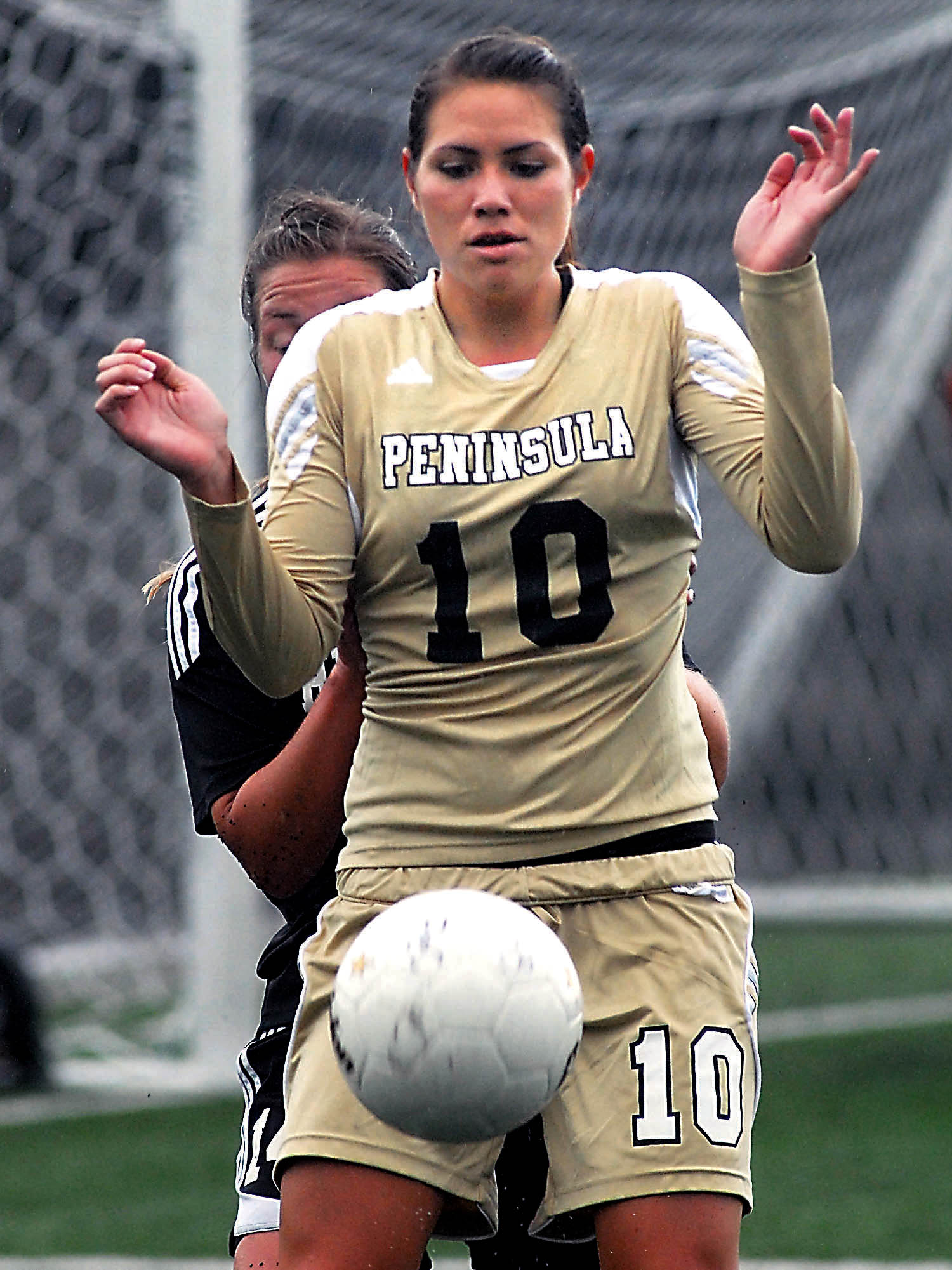 Peninsula College's Bri Afoa blocks an incoming ball during a game against Highline last month in Port Angeles. Afoa