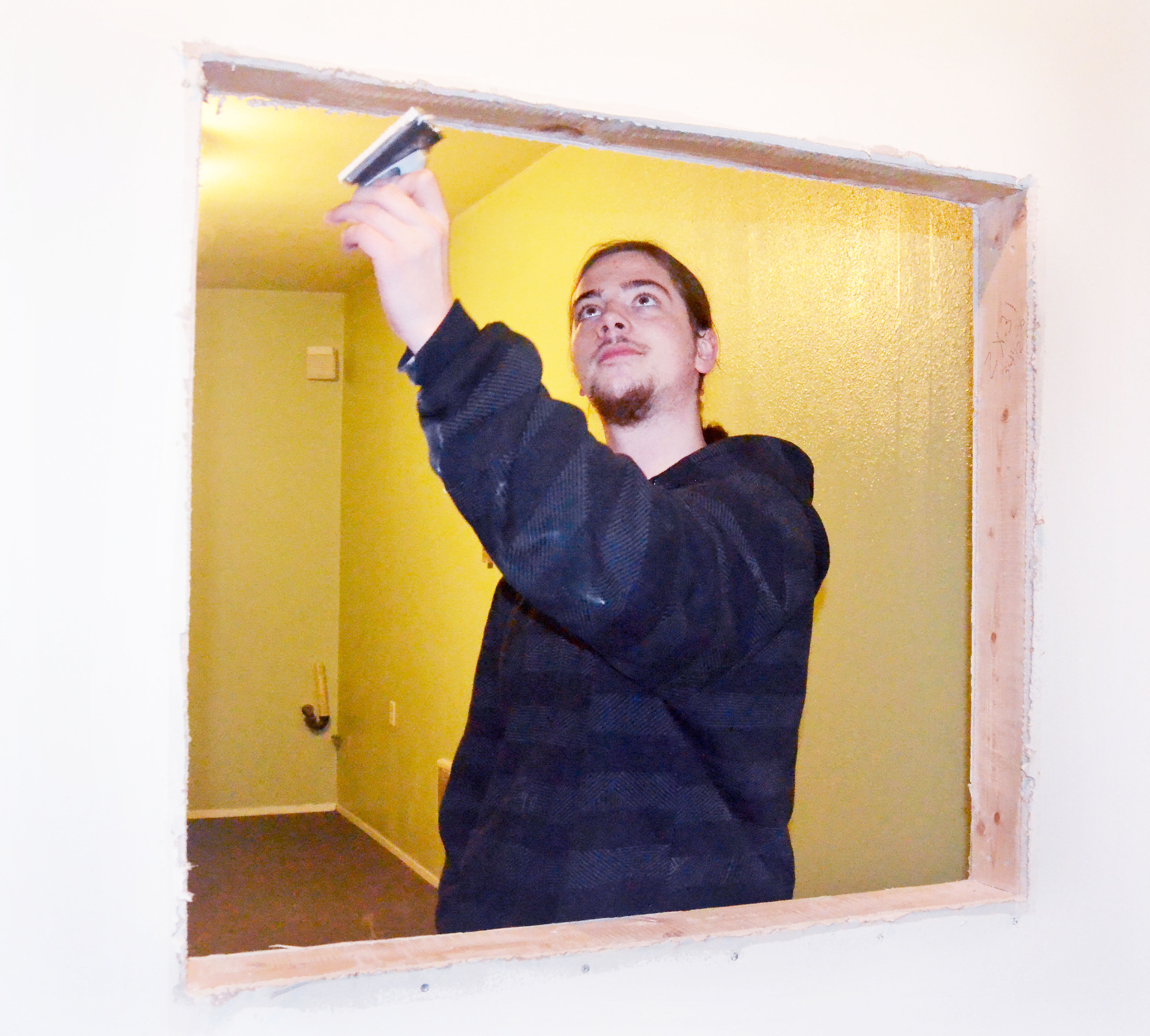 Gracen Hook prepares the service window in a medical pot dispensary he is opening in Port Townsend within the next few weeks. Hook