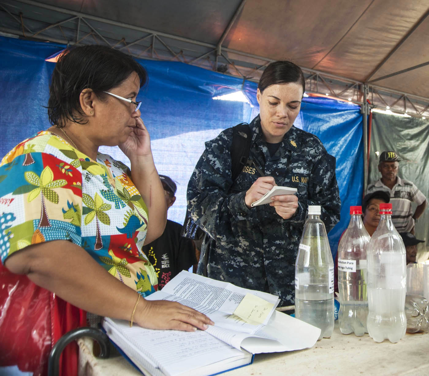 Lt. Lauren Moses of Port Townsend jots down medical information and medicinal needs from Guiuan