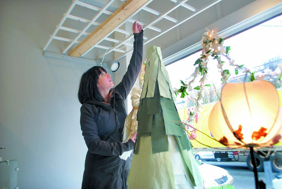 Artisans on Taylor owner Anna Nasset decorates her gallery's window on Wednesday