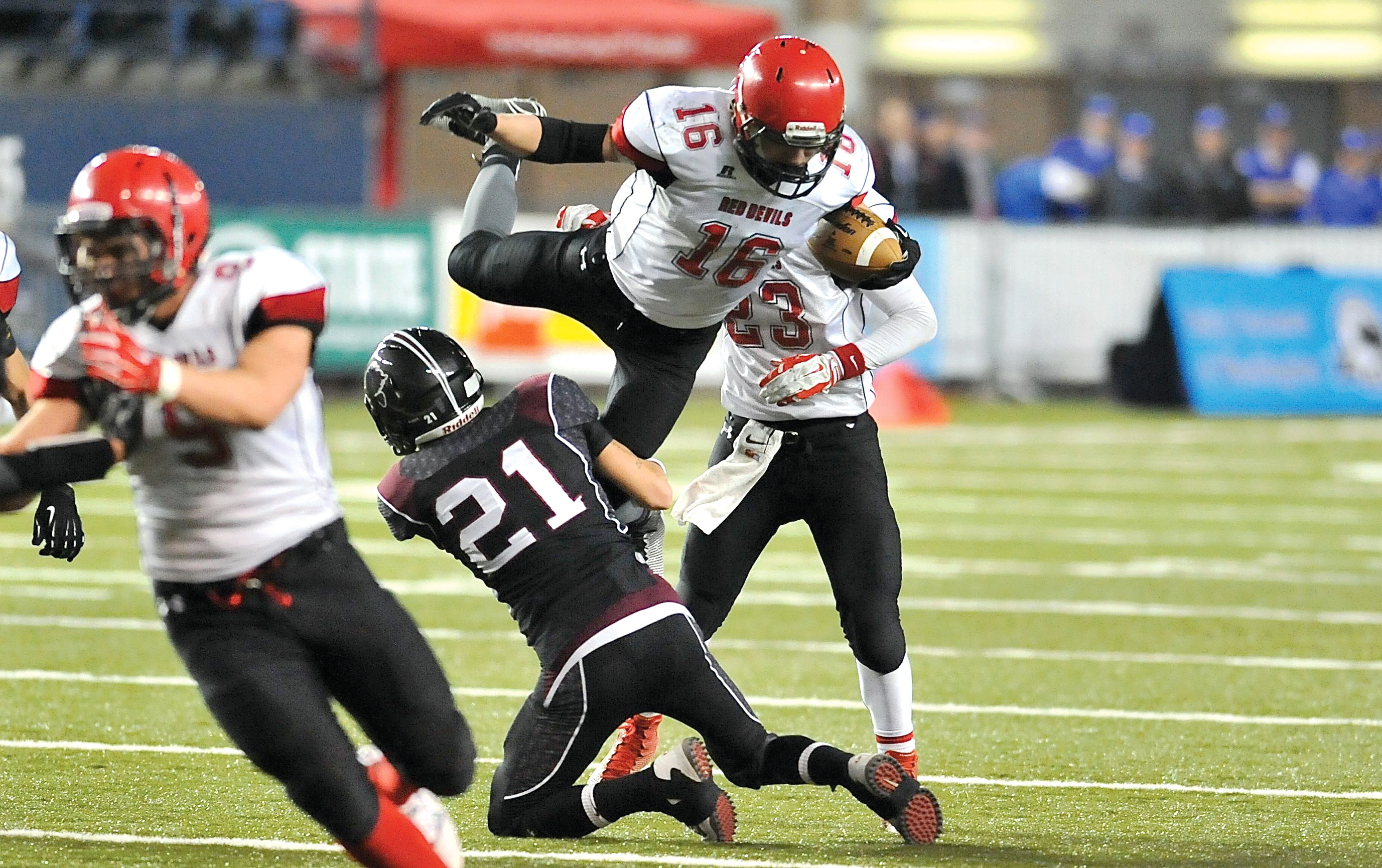 Neah Bay's Cole Svec (16) tries to leap over Lummi's Dean Williams (21). Svec was stopped on this play