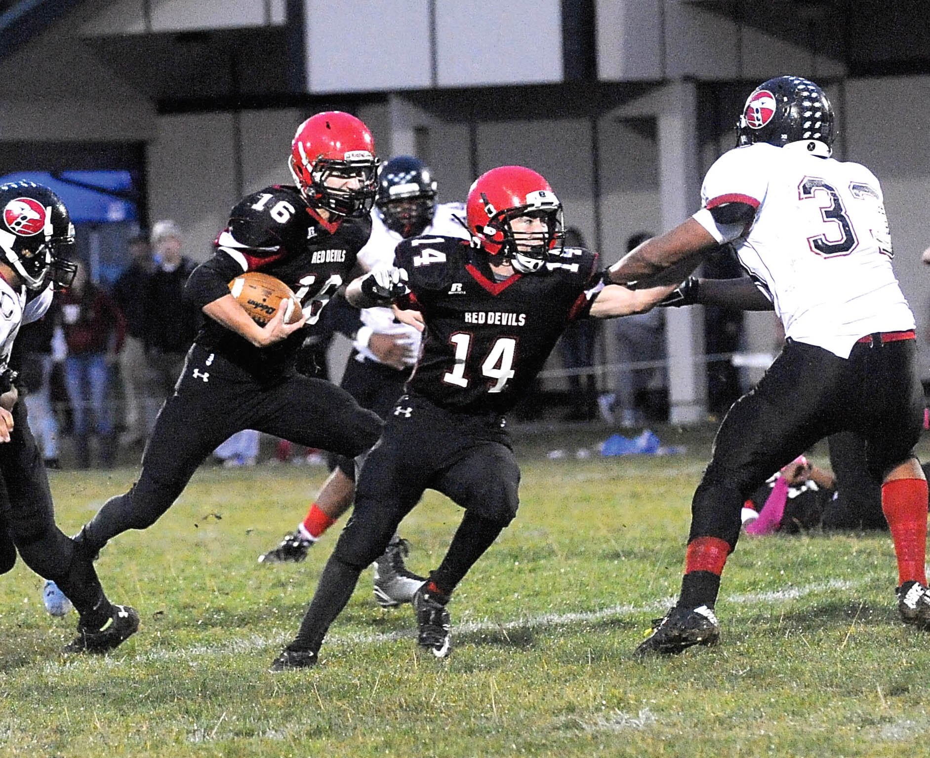 Neah Bay's Cole Svec (16) runs behind the blocking of Cameron Buzzell (14) against Tulalip Heritage earlier this season. The Red Devils play in their fourth consecutive Class 1B state championship game Saturday at the Tacoma Dome. Lonnie Archibald/for Peninsula Daily News