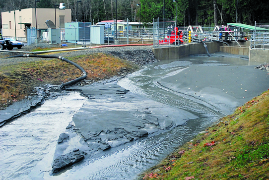 Silt-laden water is flushed into a side channel near the water intake for the industrial water treatment plant at the Elwha River west of Port Angeles Keith Thorpe/Peninsula Daily News