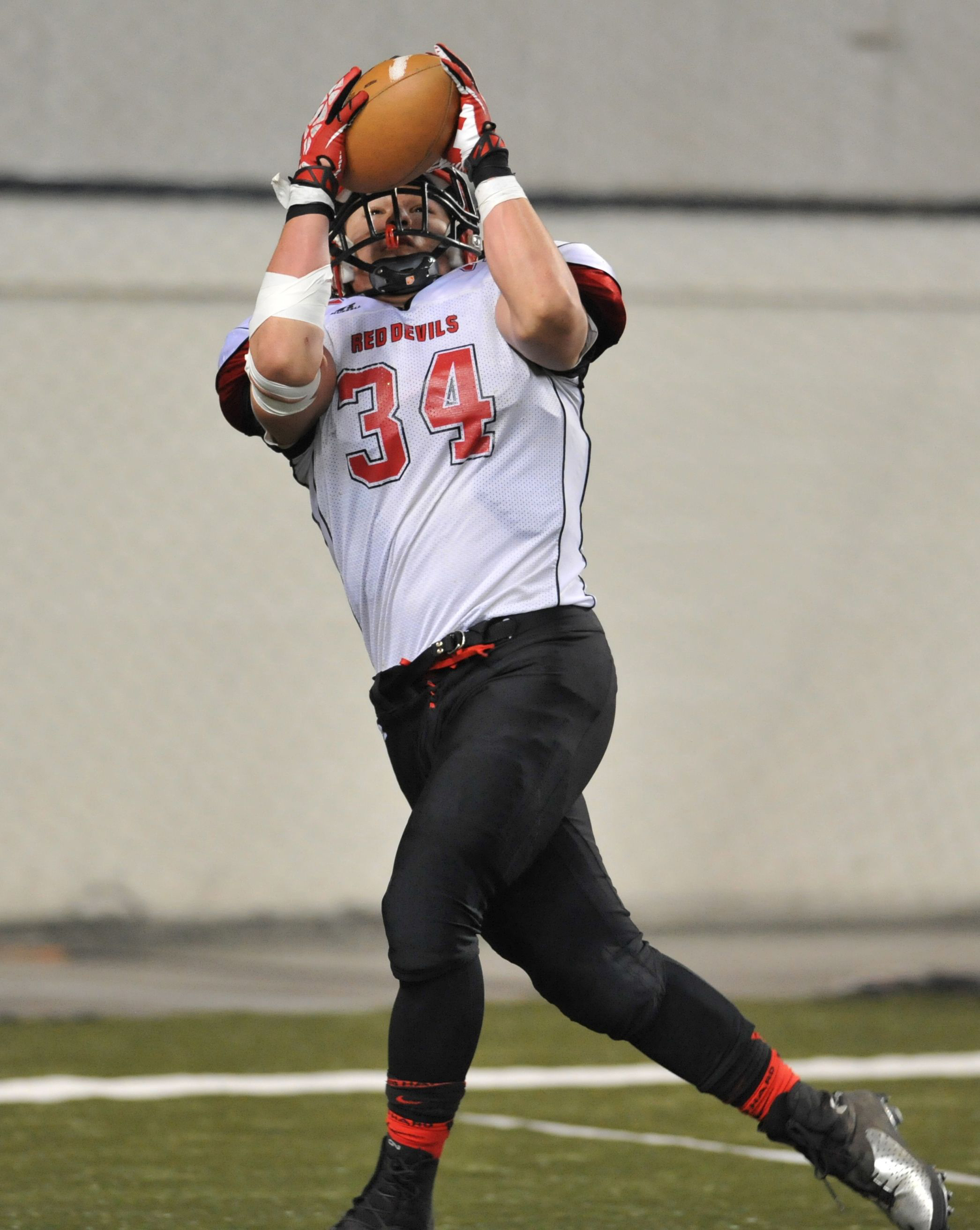 Neah Bay's John Reamer hauls in a touchdown catch during the class 1B semifinals. Reamer is one of the many Red Devils who played on Neah Bay's football and basketball runner-up teams last year. Jeff Halstead/for Peninsula Daily News