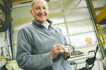 Ken Davis sands a chickadee he has carved as a Christmas gift for one of his grandchildren. Davis is the featured artist at Saturday's Pacific Northwest Wood Artisans show at Pioneer Park in Sequim. Joe Smillie/Peninsula Daily News