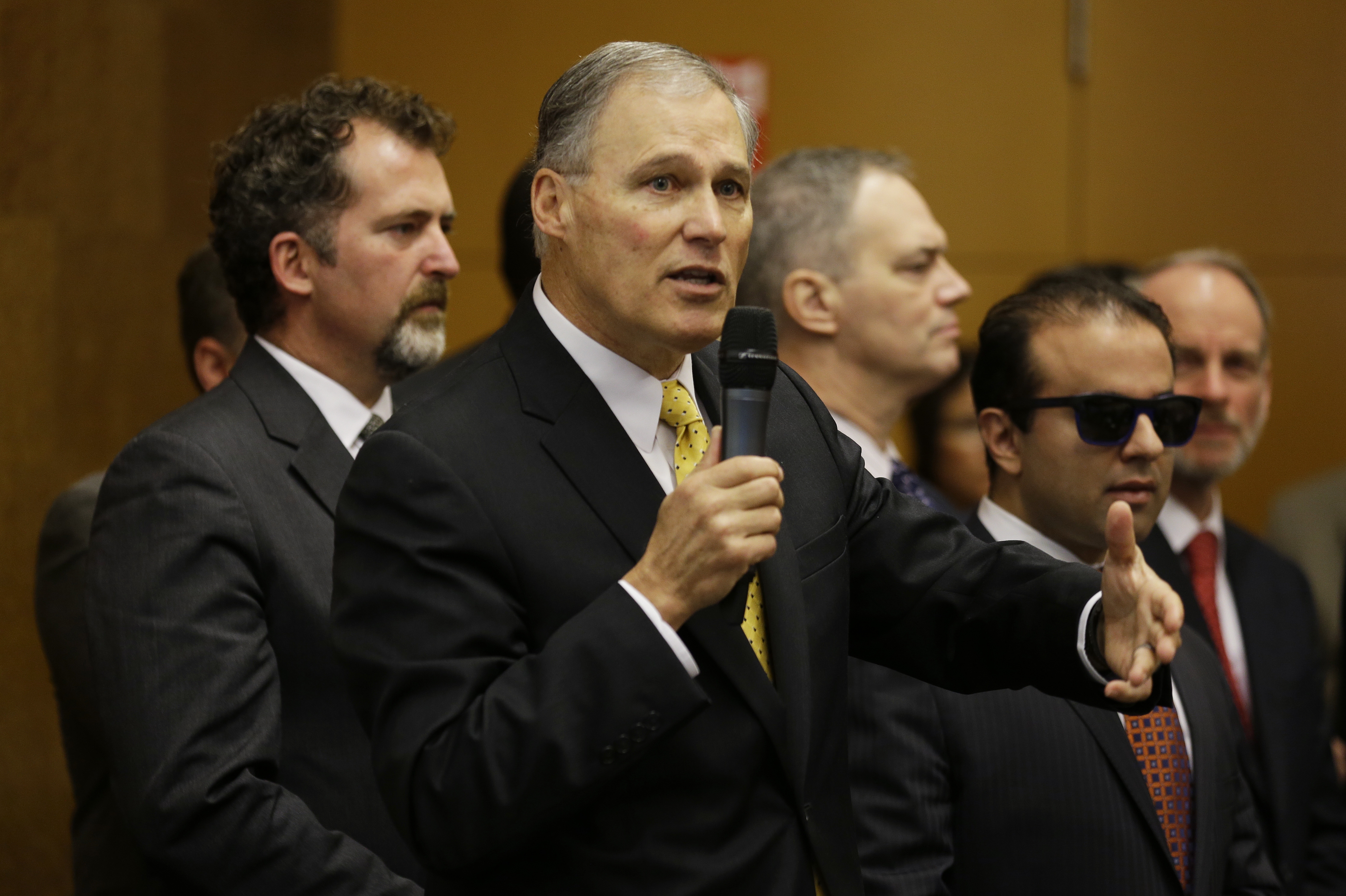 Gov. Jay Inslee speaks Wednesday at REI's flagship store in Seattle. The Associated Press