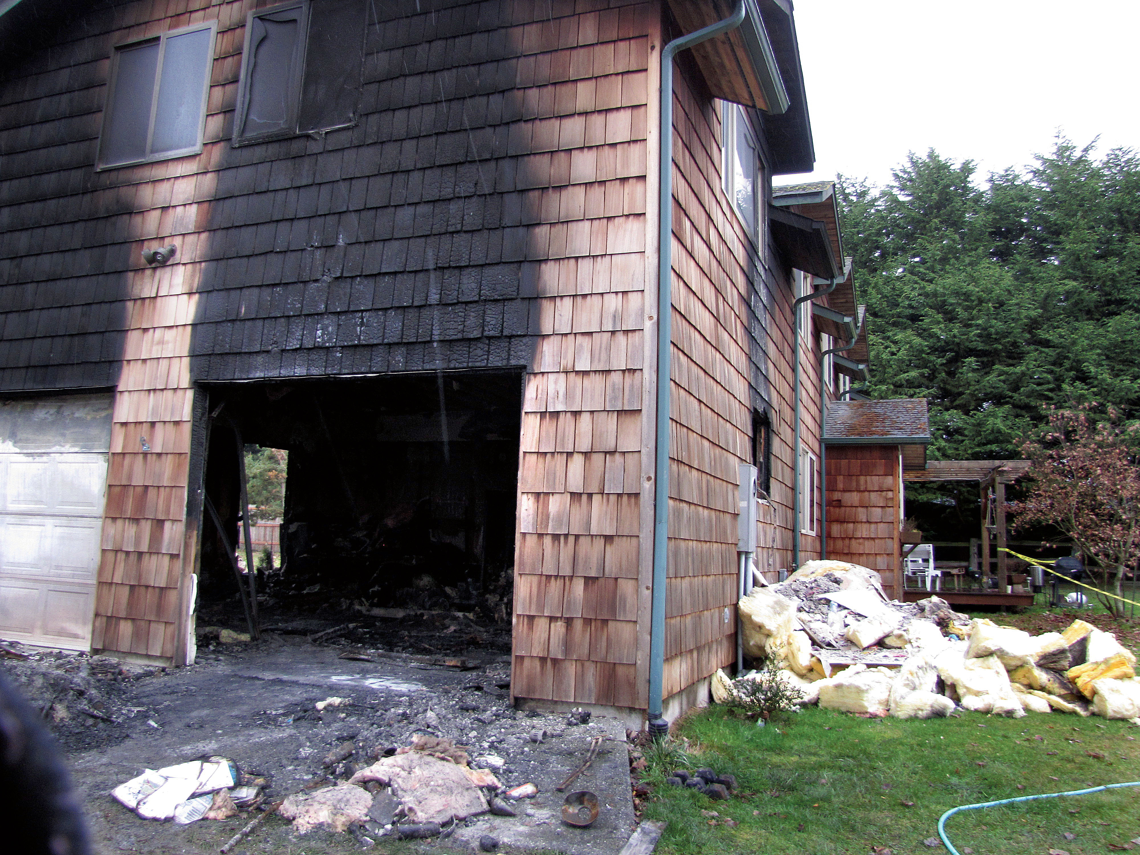 Seven people were initially left homeless after a house fire at 112 J Shea Way east of Port Angeles destroyed the garage and an addition. Arwyn Rice/Peninsula Daily News