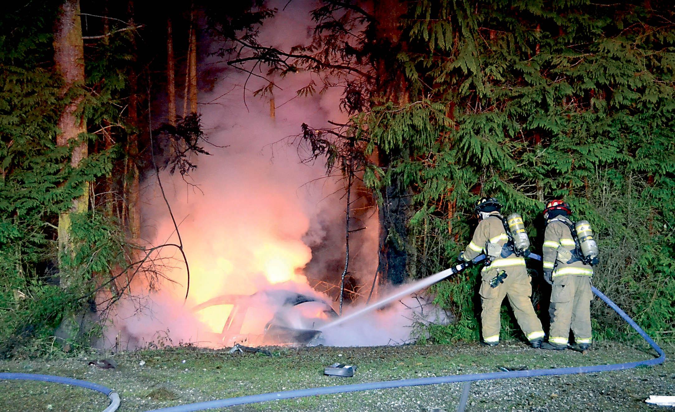 East Jefferson Fire-Rescue firefighters douse a car that burst into flames after it crashed early Christmas morning at Beckett Point Road and Marrakech Circle. Bill Beezley/East Jefferson Fire-Rescue