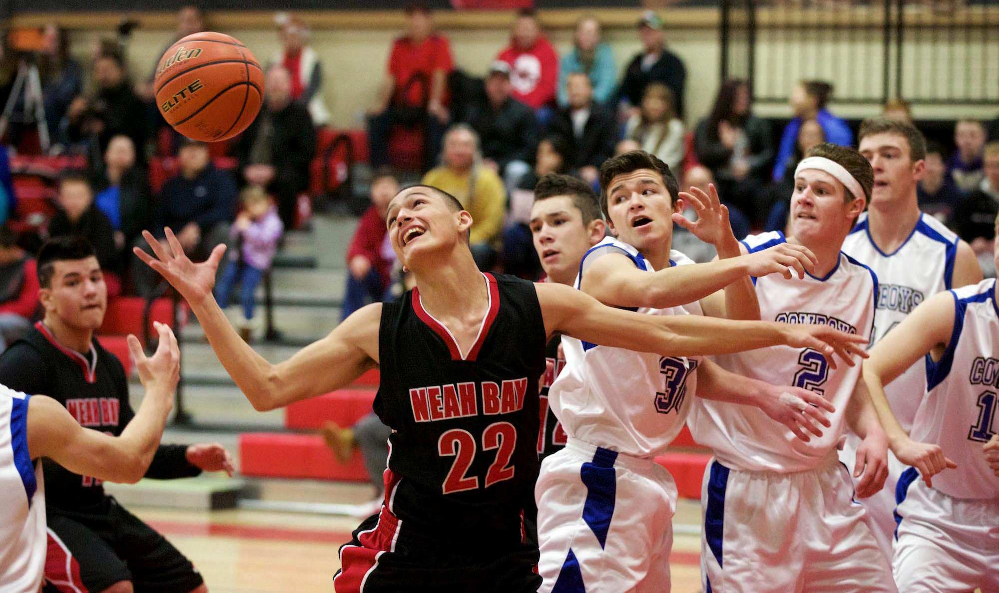 Neah Bay's Kenrick Doherty (22) goes for a rebound against Chimacum's Matthew Torres (30) and Myles Hundley (2). Steve Mullensky/for Peninsula Daily News