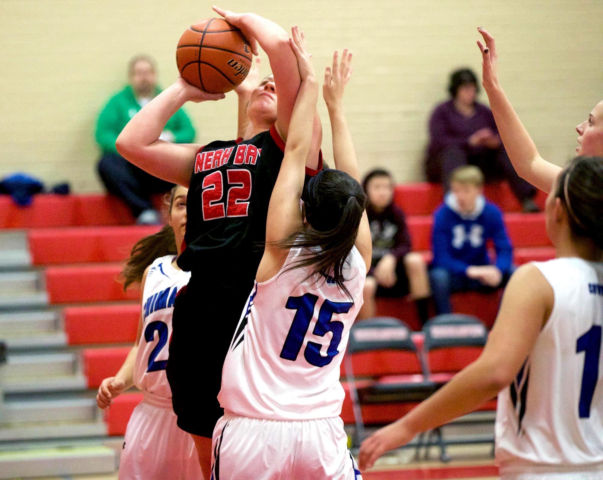 Neah Bay's Faye Chartraw (22) is fouled by Chimacum's Bailey Castillo during the opening game of the Crush in the Slush tournament at Port Townsend High School. The Red Devils defeated the Cowboys 50-38. Steve Mullensky/for Peninsula Daily News