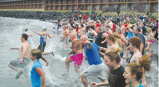 A crowd rushes into the water  from Hollywood Beach in Port Angeles last Jan. 1. Peninsula Daily News