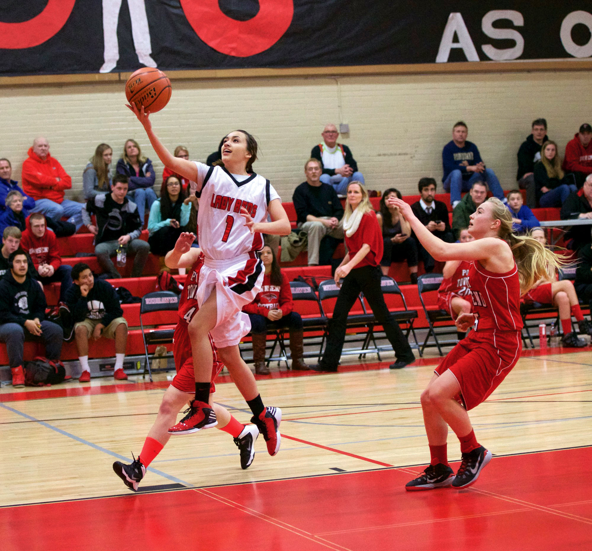 Neah Bay's Kiawana Doherty soars in for a layup as Port Townsend's Kaitlyn Meek