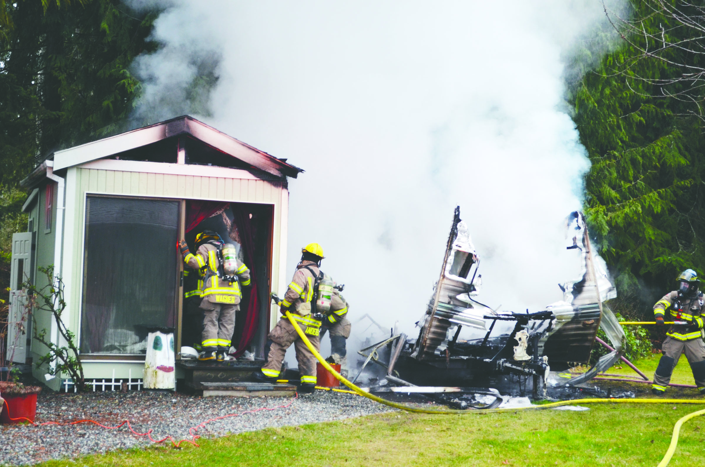 Firefighters with Clallam County Fire District No. 3 work to extinguish a fire at 171 Olympian Way