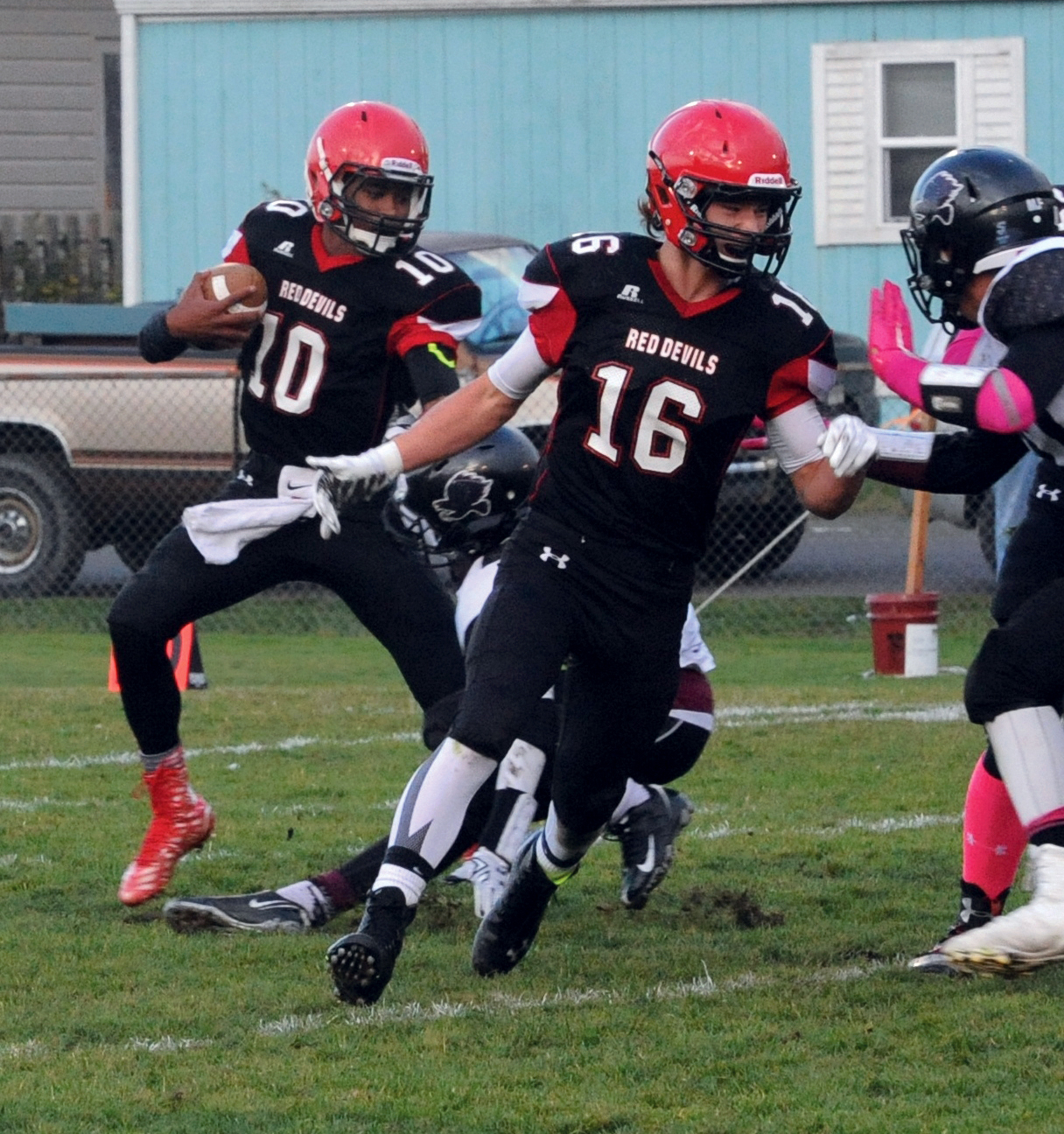 Neah Bay quarterback Rwehabura Munyagi Jr. (10) looks for a hole against Lummi as running back Cole Svec (16) blocks. Lonnie Archibald/for Peninsula Daily News