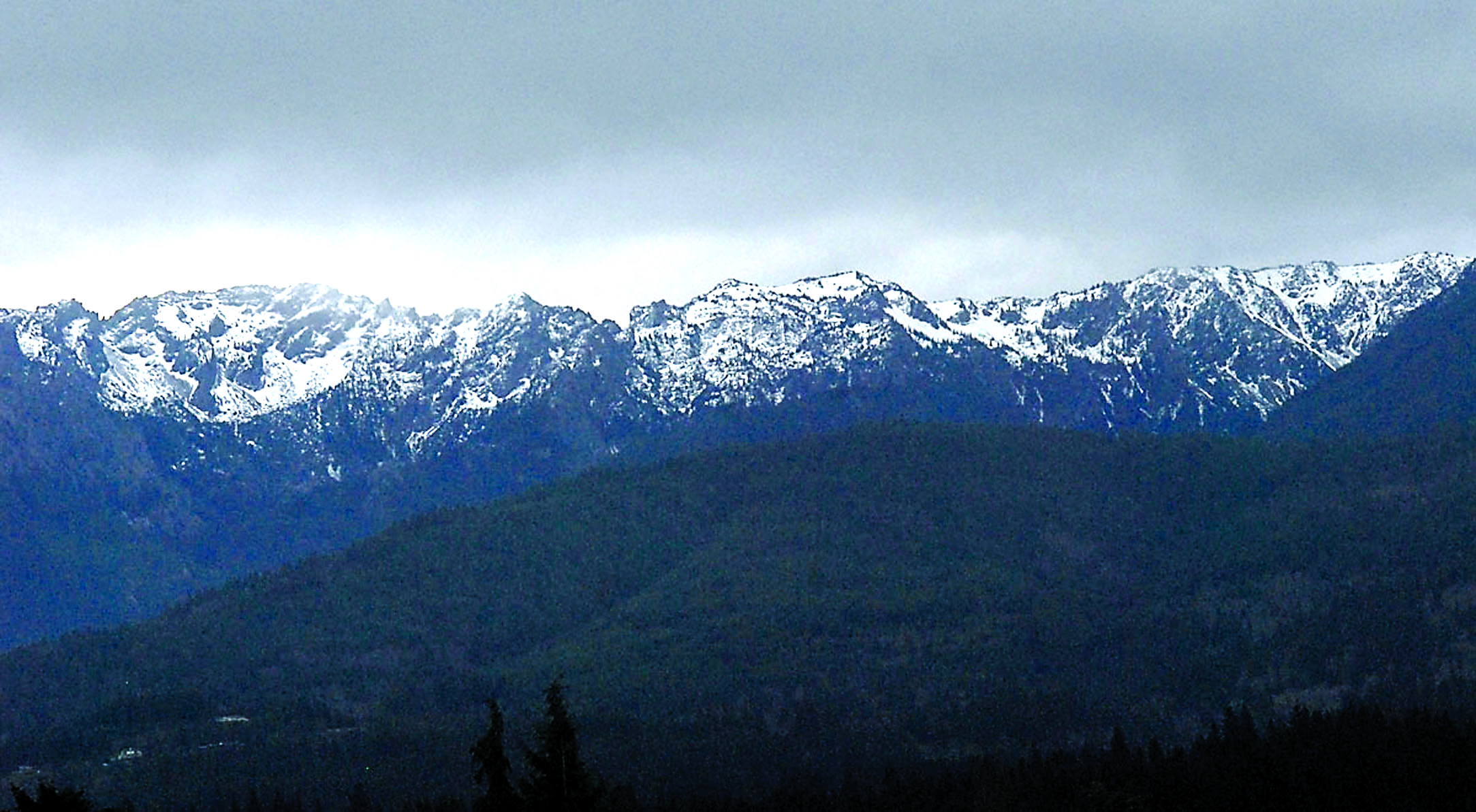 Snow dusts the northern face of Klahhane Ridge south of Port Angeles recently. Water content in the Olympic Mountain snowpack is at a mere 24 percent of normal levels.  — Keith Thorpe/Peninsula Daily News