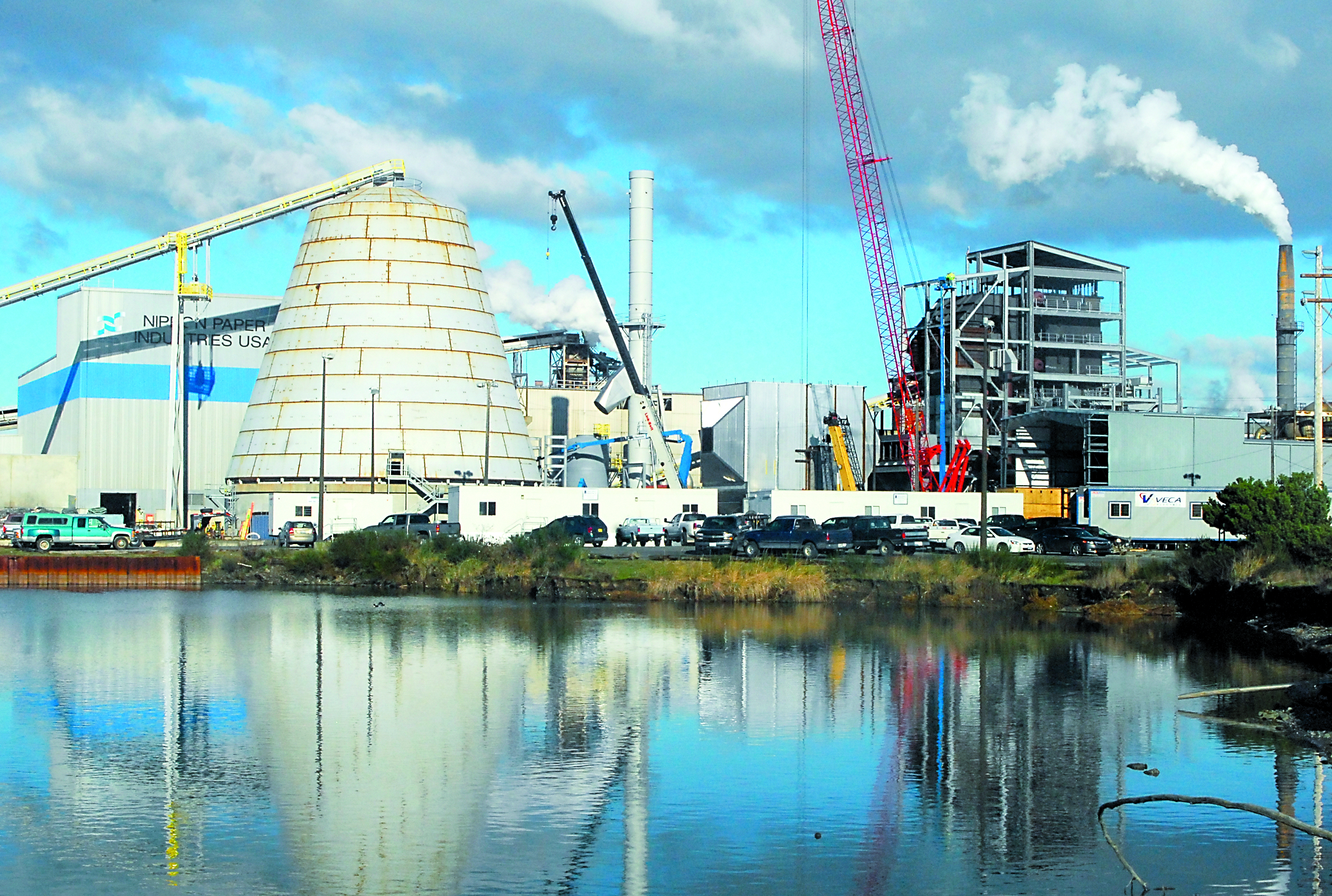 Work continues Friday on the construction of a biomass-fueled cogeneration plant at the Nippon Paper Industries USA mill in Port Angeles. A hearing is scheduled Monday on the cooling tower permit. Keith Thorpe/Peninsula Daily News