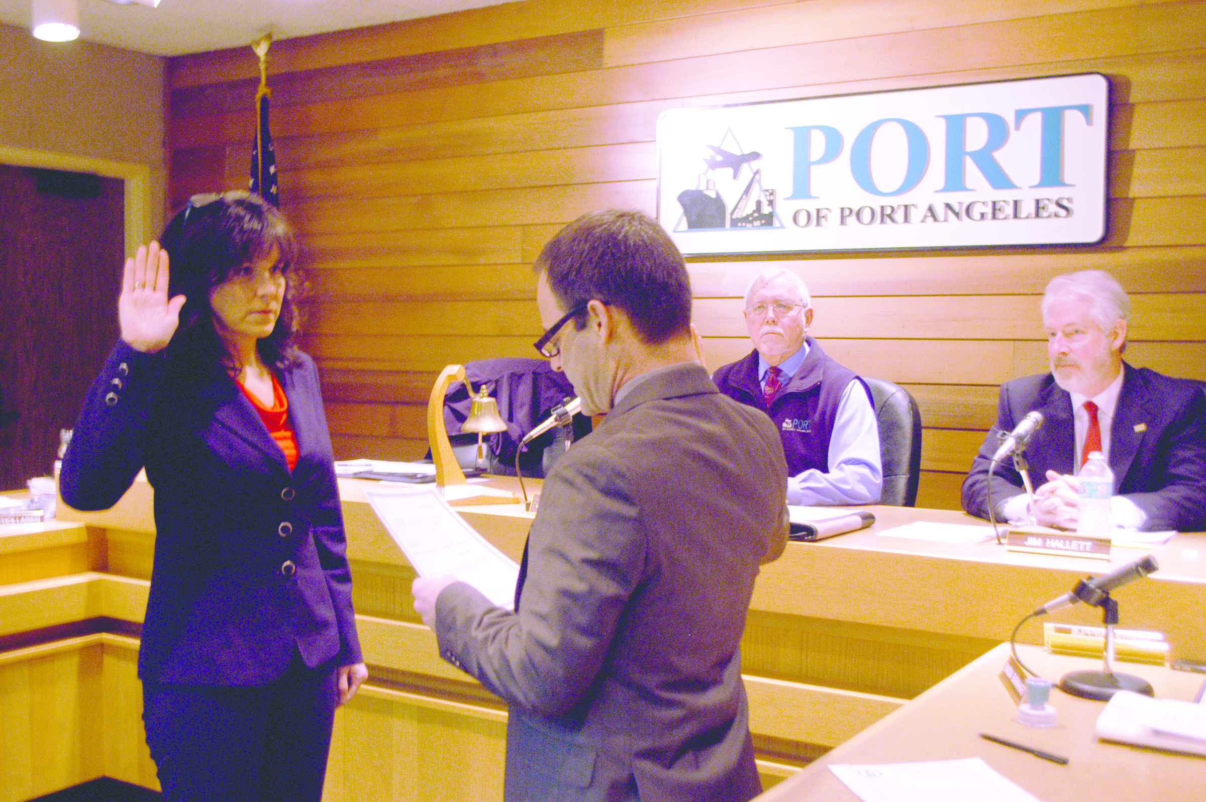 New Port of Port Angeles Commissioner Colleen McAleer is sworn in Monday by port attorney Simon Barnhart as the port's first female commissioner in its 90-year history while