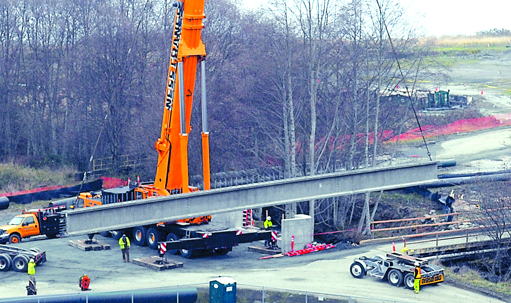 A concrete girder is hoisted into place across Ennis Creek at the site of the former Rayonier pulp mill in Port Angeles on Tuesday.  -- Photo by Keith Thorpe/Peninsula Daily News