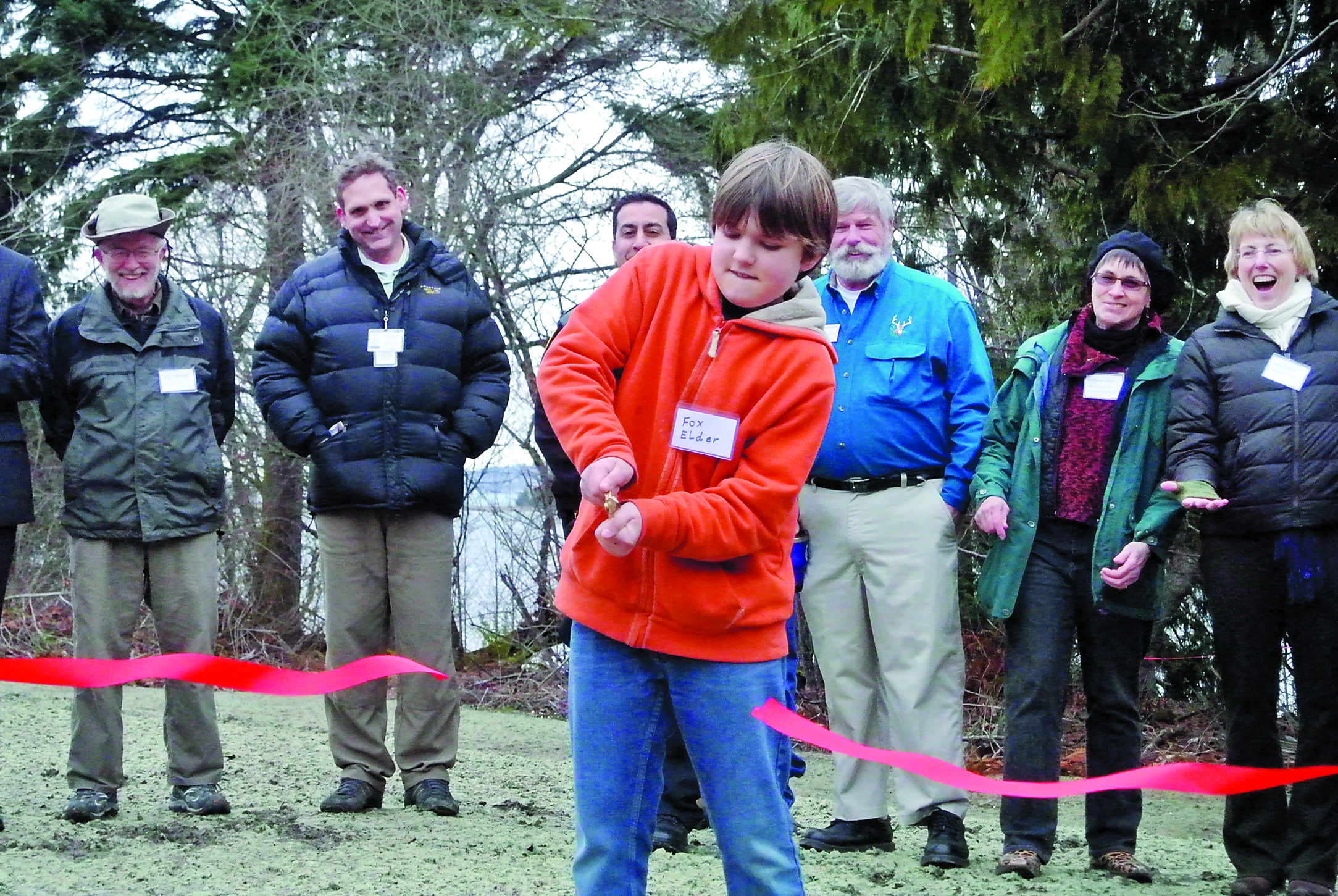 Chimacum Elementary School student Fox Elder cuts the ribbon at the opening of Irondale Beach County Park on Thursday.  -- Photo by Charlie Bermant/Peninsula Daily News