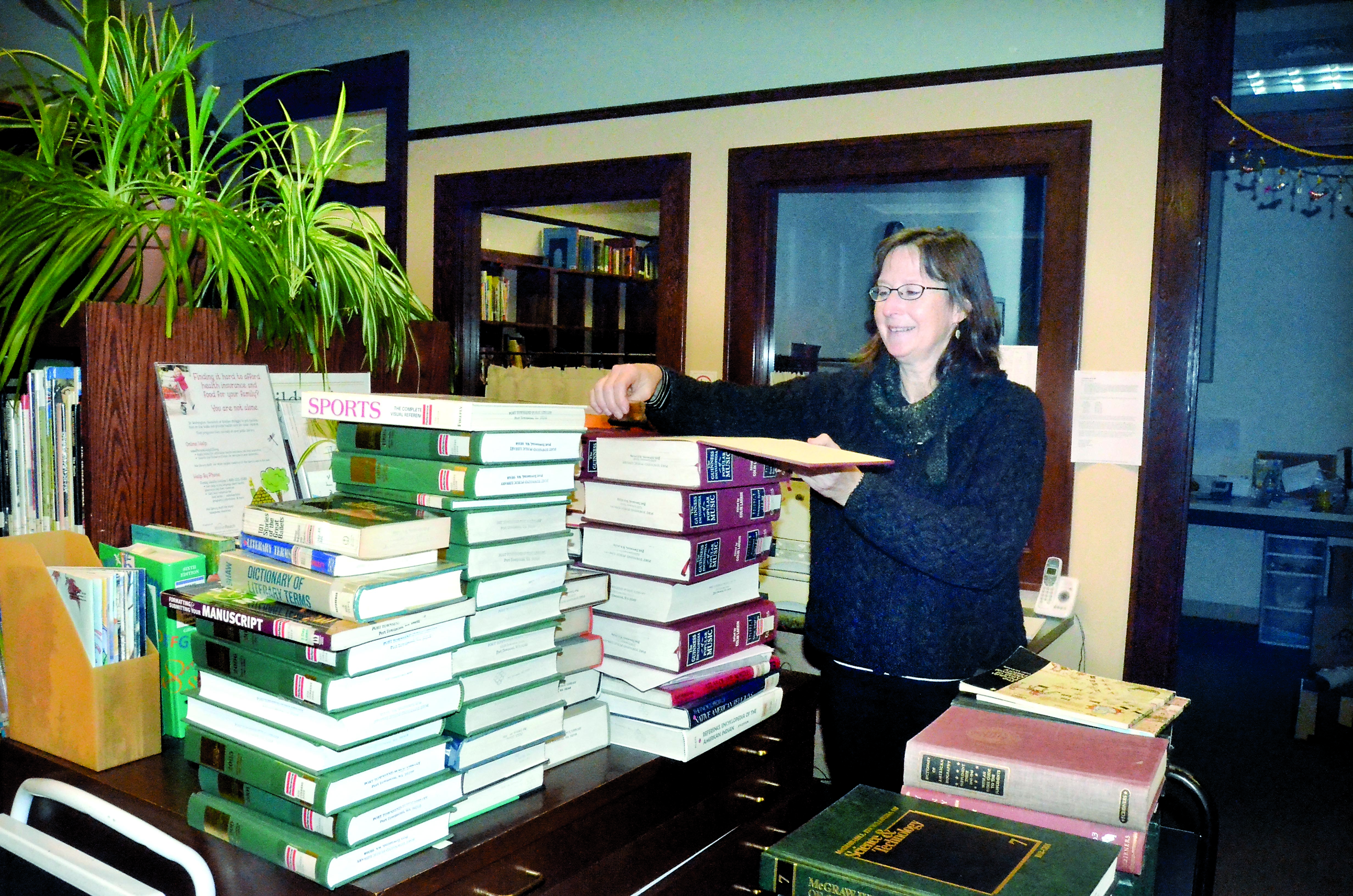 Port Townsend Library collections manager Beverly Moore catalogs some of the books that will need to be stored in anticipation of the library’s move back into the Carnegie Building