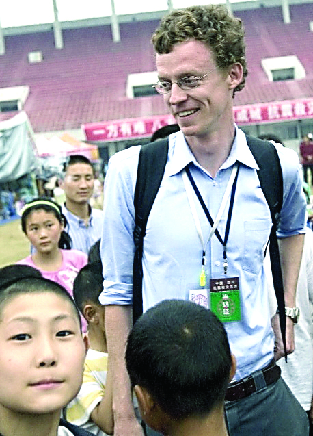 New York Times correspondent Austin Ramzy with schoolchildren before he was ordered out of China. — The Associated Press