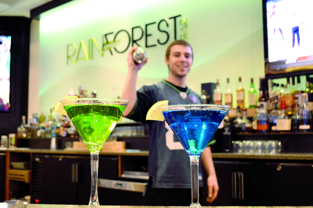 Bartender Tommy Napoli practices mixing up Seattle Seahawks-inspired drinks at the Rainforest Sports Bar at 7 Cedars Casino in Blyn. Joe Smillie/Peninsula Daily News