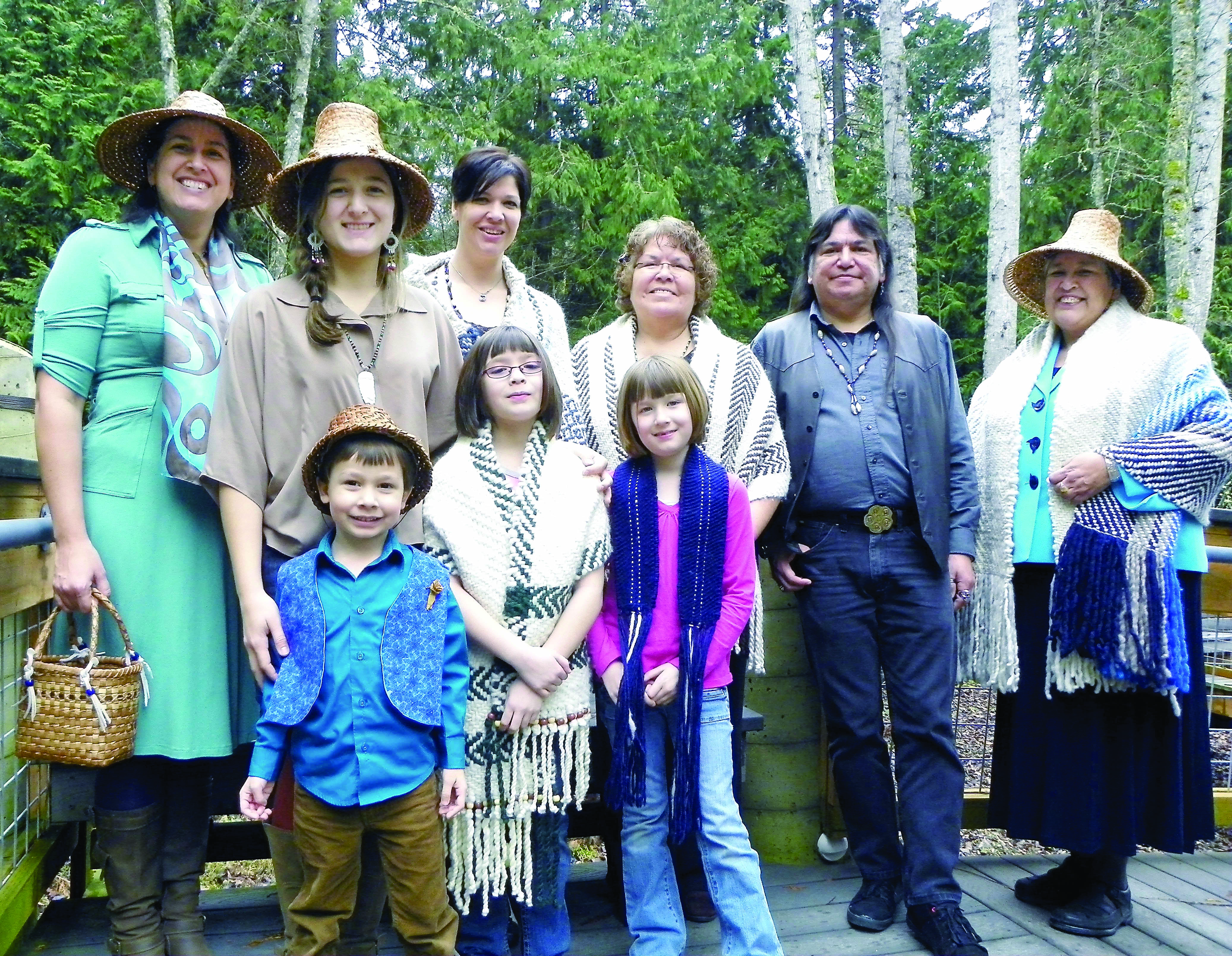 Members of the Johnson family gather on the steps of the Peninsula College Longhouse. They are