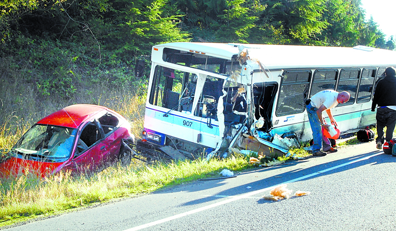 The wreckage of a Clallam Transit bus and another vehicle sit in the ditch near the site where the bus collided with a camper pickup truck on U.S. Highway 101 near Laird's Corner west of Port Angeles in September 2009. Keith Thorpe/Peninsula Daily News