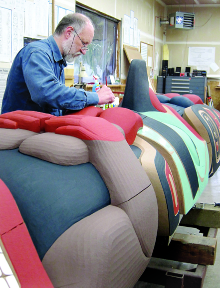 Master carver Dale Faulstich paints a totem in the Jamestown S'Klallam tribe's “House of Myths” carving shed in Blyn recently. Faulstich gave a presentation on totem carving Friday and a tour of the “House of Myths” on Saturday. Betty Oppenheimer/Jamestown S'Klallam tribe