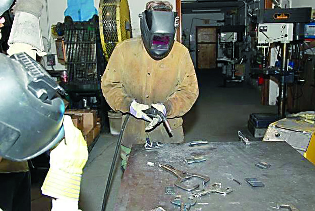 A Boy Scout practices welding techniques during a welding course. Enclume in Port Hadlock provided space and equipment for Several scouts during the merit badge clinic.