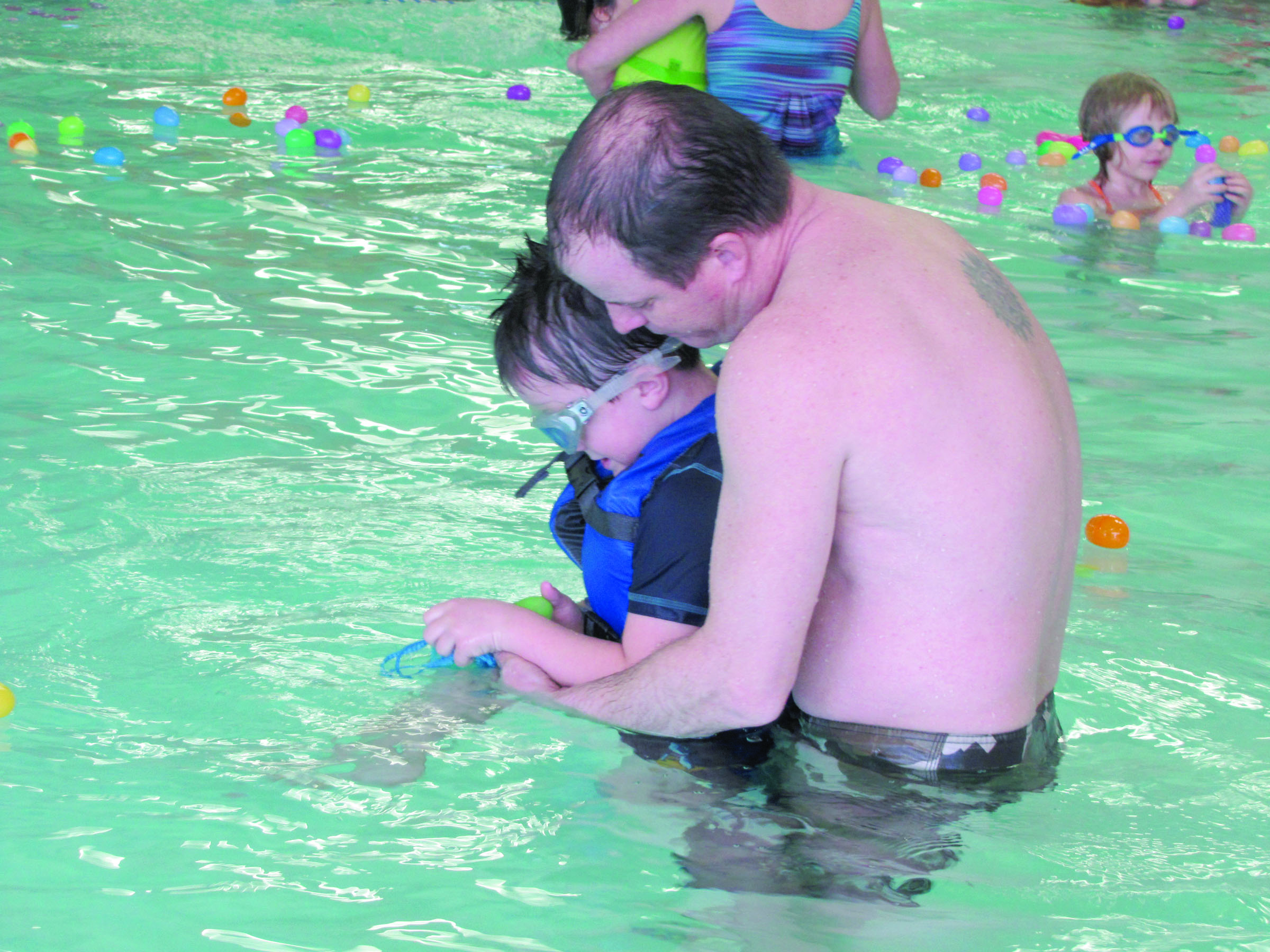 Brett McCallister of Port Angeles helps his son