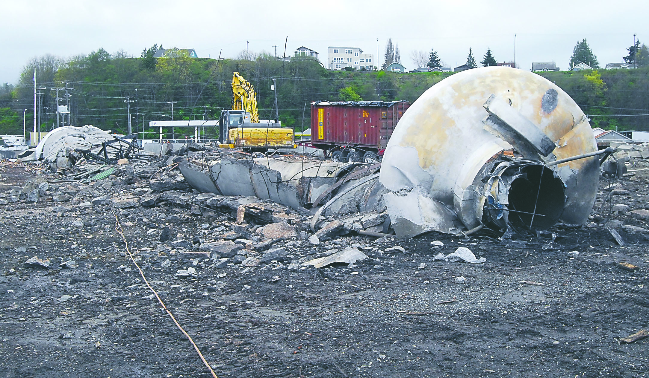 The remains of the Peninsula Plywood smokestack lie in wreckage Tuesday after it was taken down with a combination of explosives and brute force Monday evening in Port Angeles. Keith Thorpe/Peninsula Daily News