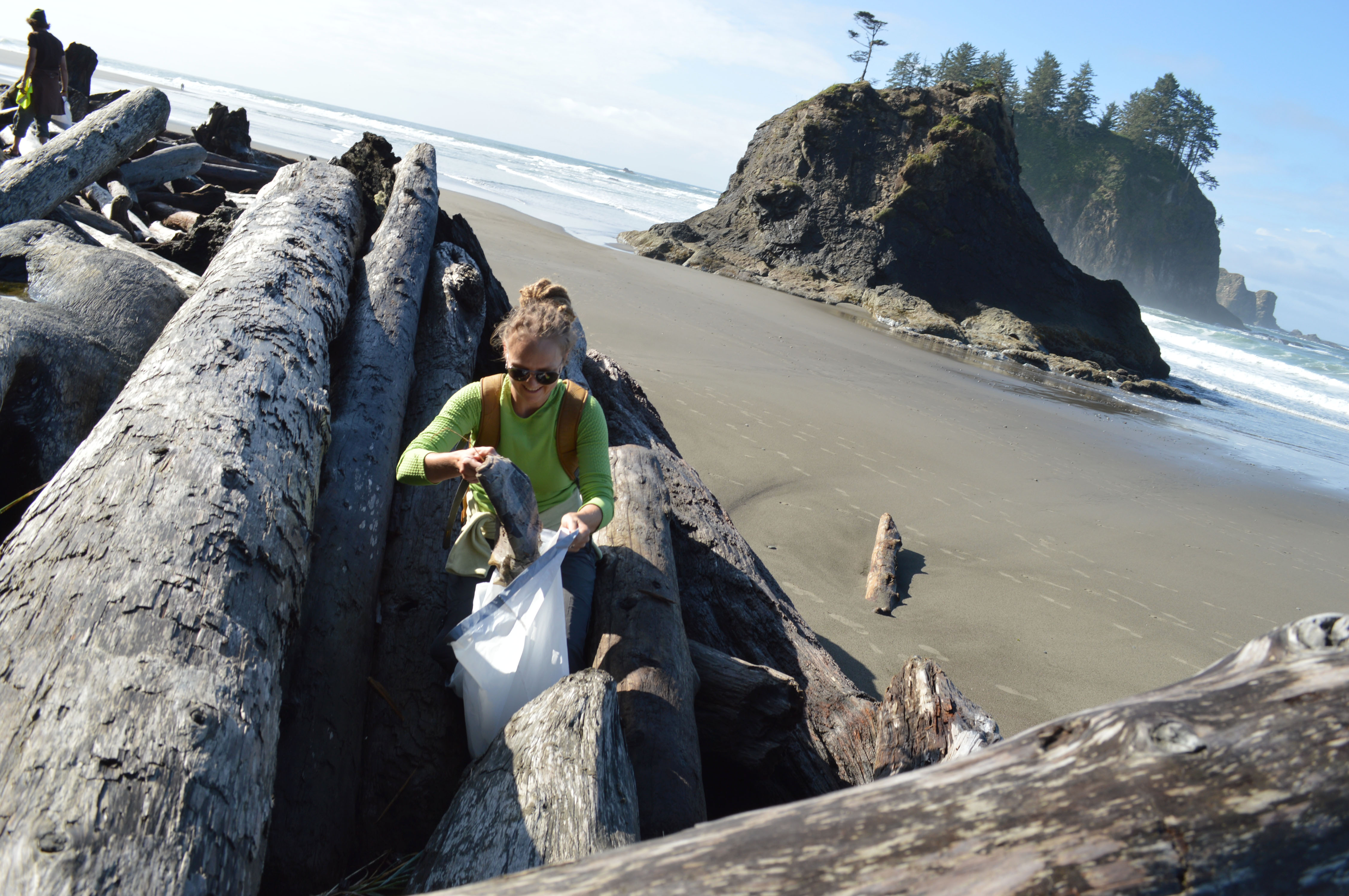 Karlyn Langjahr of Port Angeles pulls a wad of newspaper from the driftwood on 2nd Beach at La Push during the Washington CoastSavers' beach cleanup last September. The organization has put together another cleanup of area beaches on April 19. Joe Smillie/Peninsula Daily News