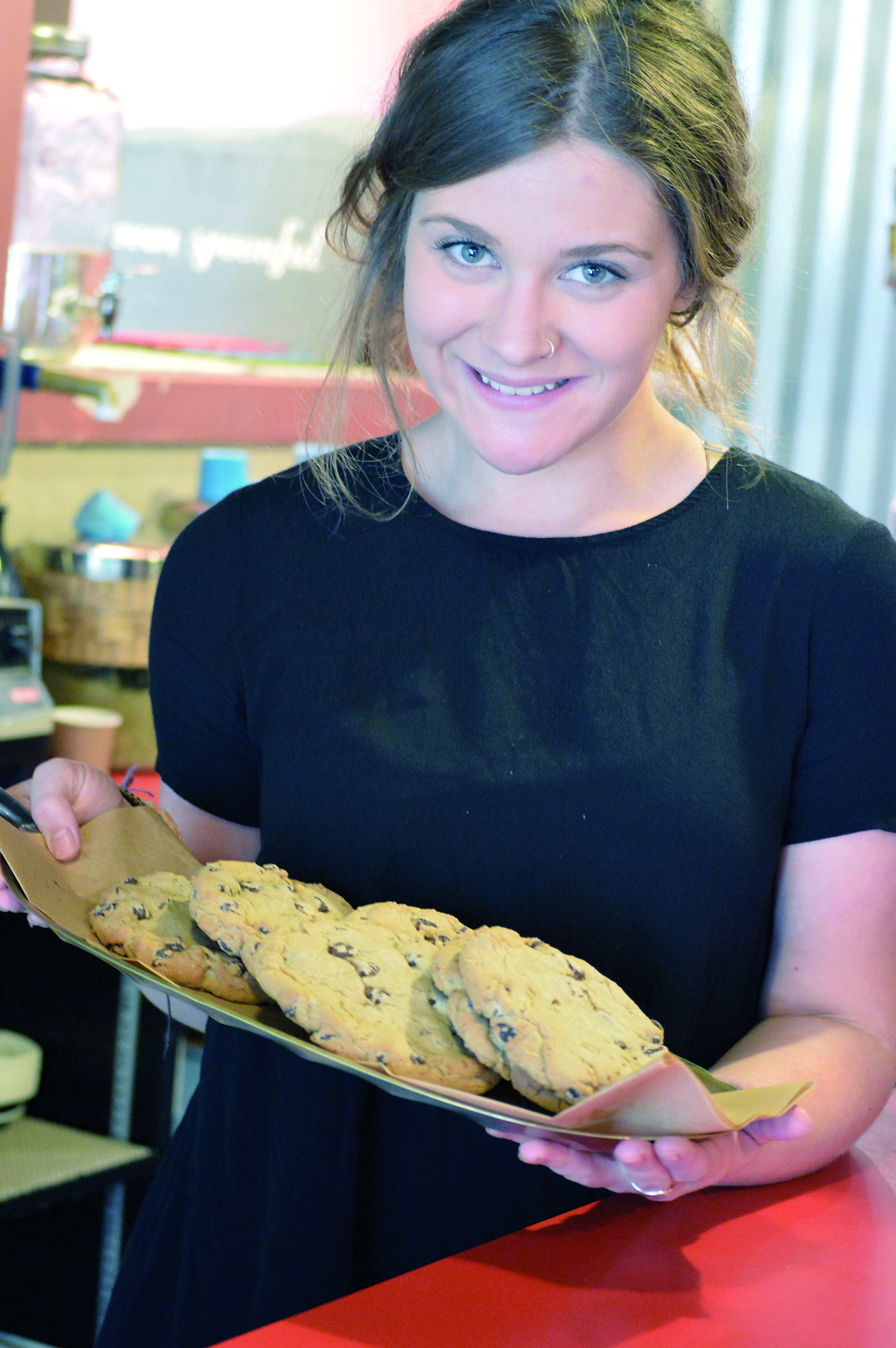 Jasmine Long cradles a plate of Oven Spoonful's chocolate-chip cookies.  —Photo by Diane Urbani de la Paz/Peninsula Daily News