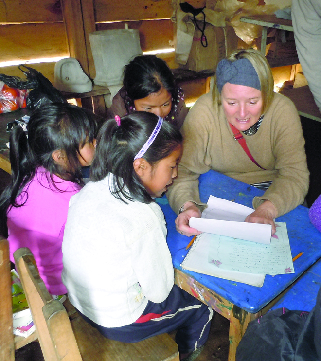 Dr. Claire Haycox of Sequim confers with girls who are part of an enrichment program in Chiapas