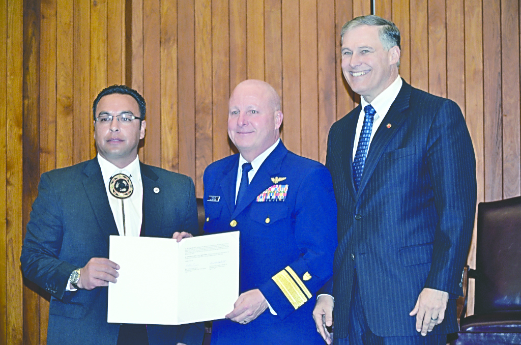 Makah Tribal Chairman Timothy J. Greene Sr. holds the memorandum of agreement alongside Coast Guard Rear Adm. Keith A. Taylor and Gov. Jay Inslee.  -- Photo by Meredith Parker/Makah Tribal Council