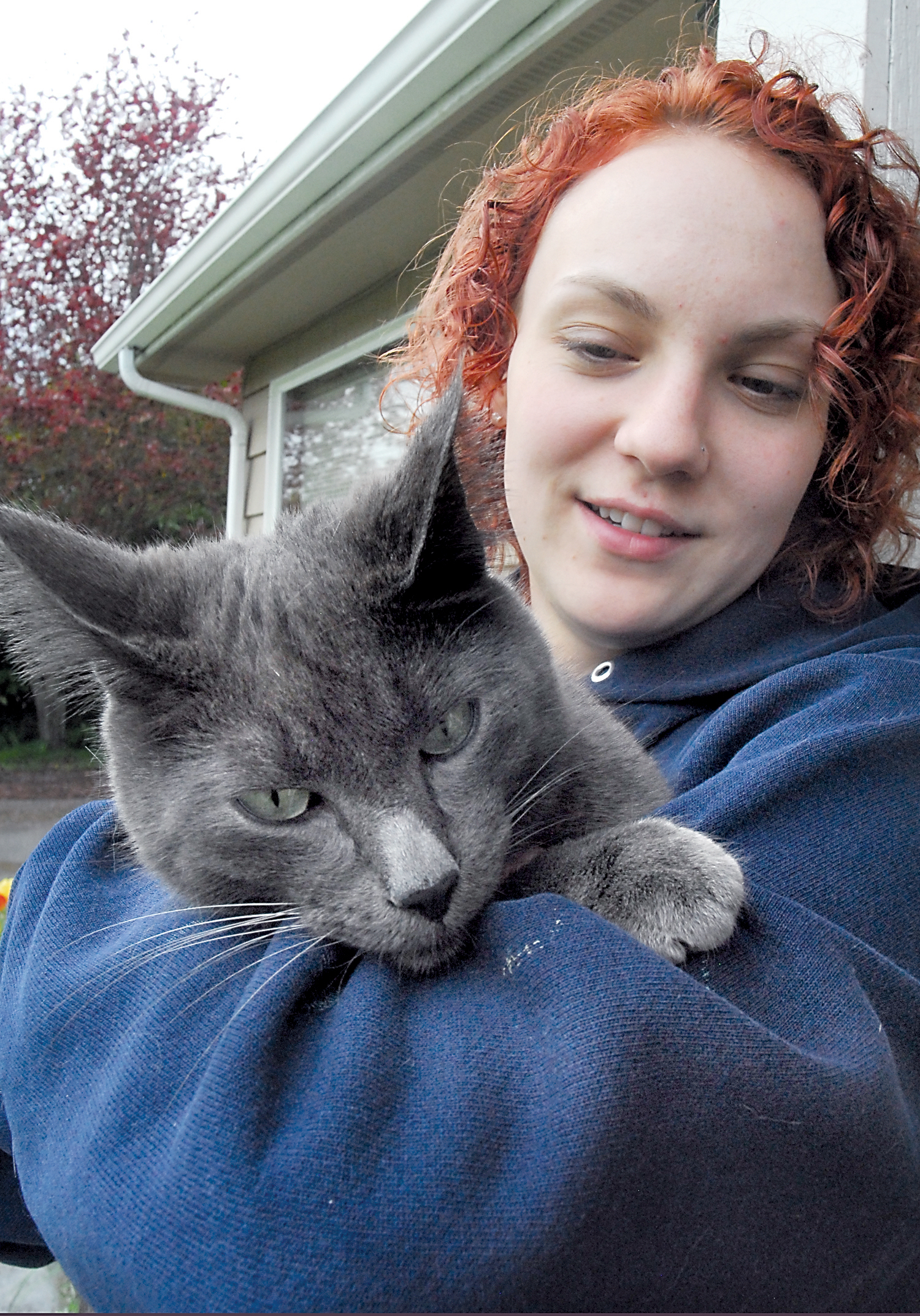 Gabriel Sanwald of Port Angeles holds Storm shortly after the cat was rescued from a utility pole behind her home. Keith Thorpe/Peninsula Daily News