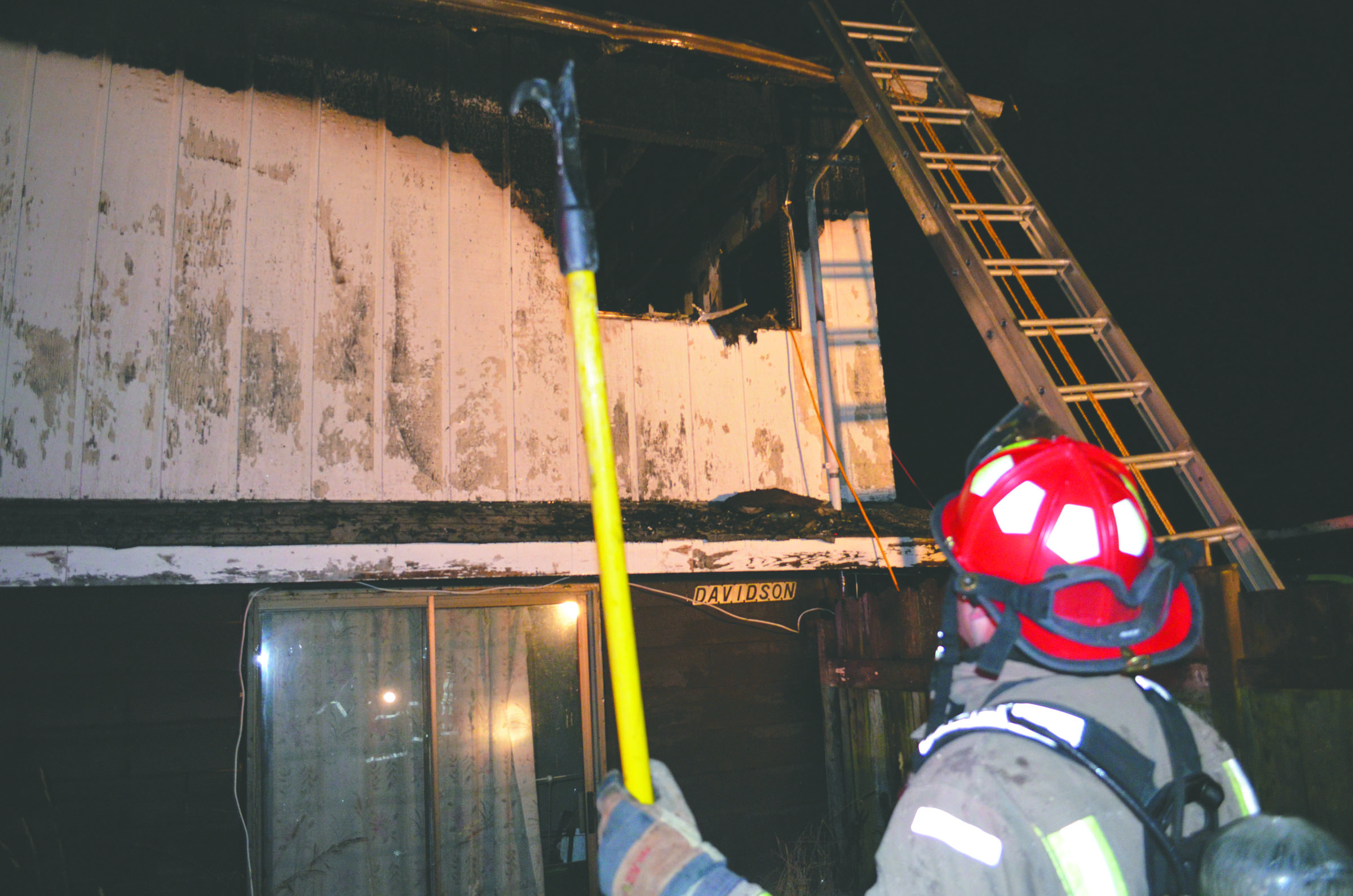 Clallam County Fire District No. 3 Lt. Jeff Albers examines the damage caused by an early Monday morning fire in Carlsborg. Clallam County Fire District No. 3