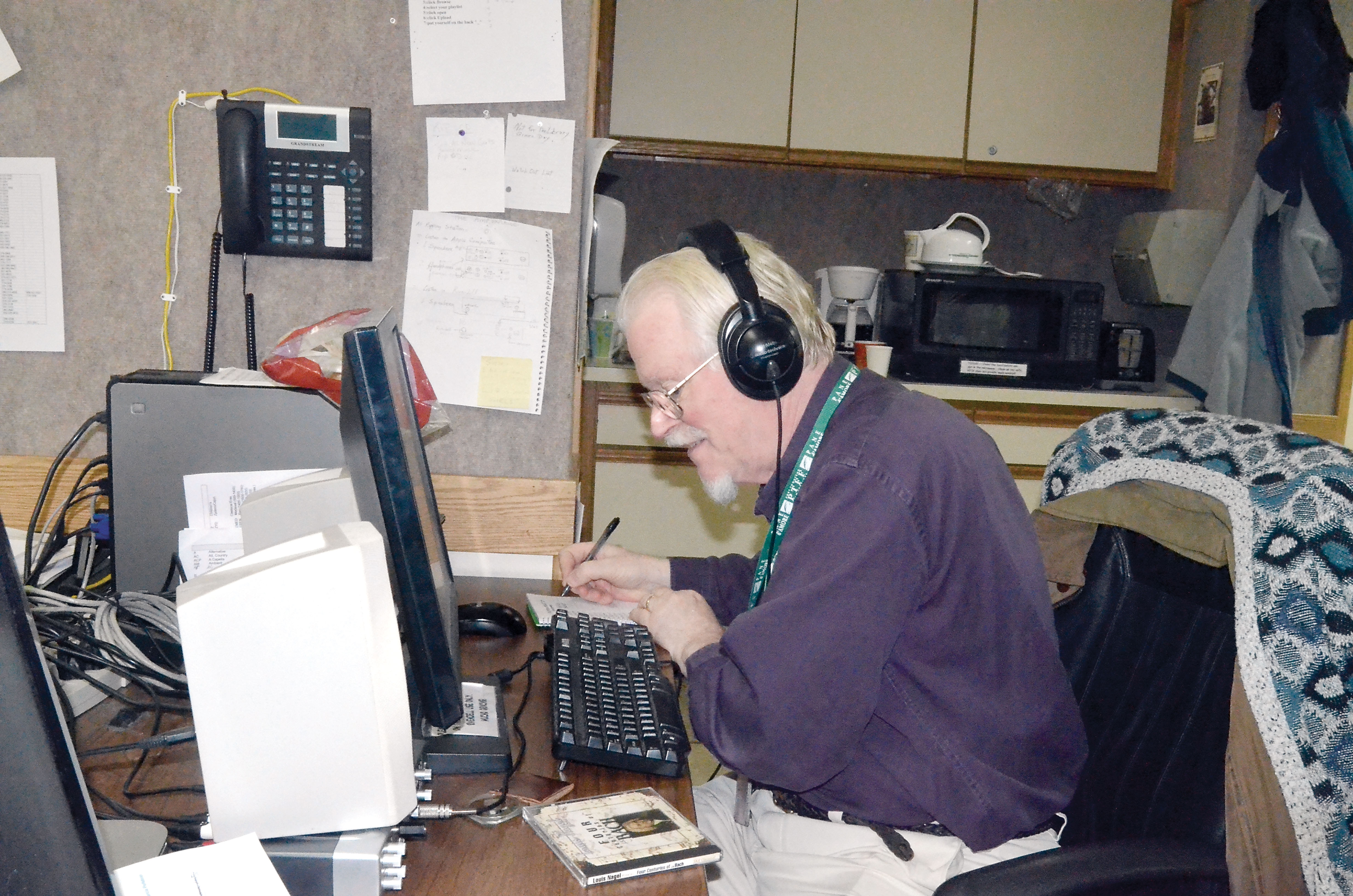 KPTZ-FM volunteer Steve Oakford logs tape at the station Tuesday. The three-year old community station is one of several nonprofit tenants at the Mountain View Campus. — Charlie Bermant/Peninsula Daily News