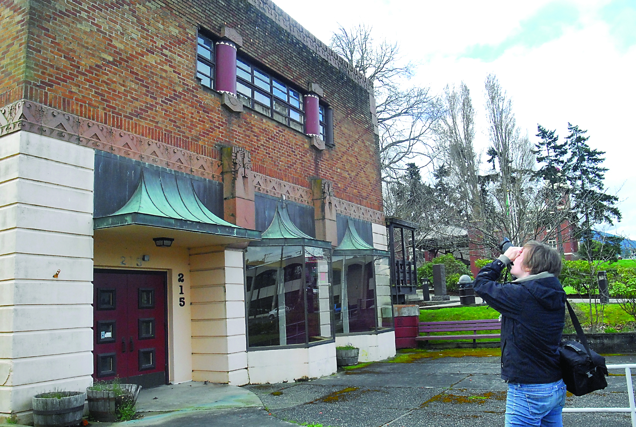 Washington Trust for Historic Preservation Communications Director Jennifer Mortensen takes photos of the front of the former Port Angeles fire hall in March. — Keith Thorpe/Peninsula Daily News