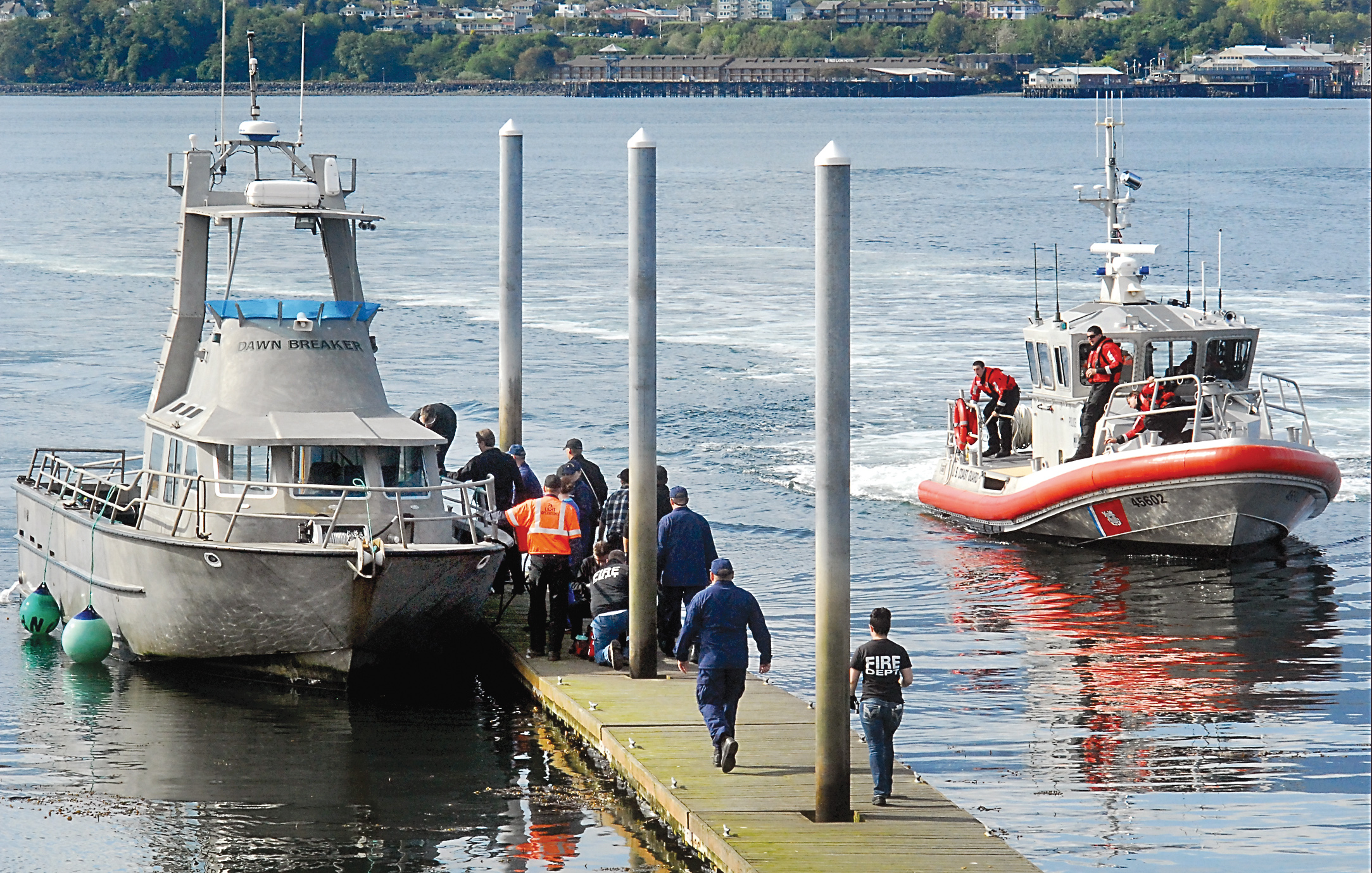 Rescue workers and Coast Guard personnel race to the Dawn Breaker