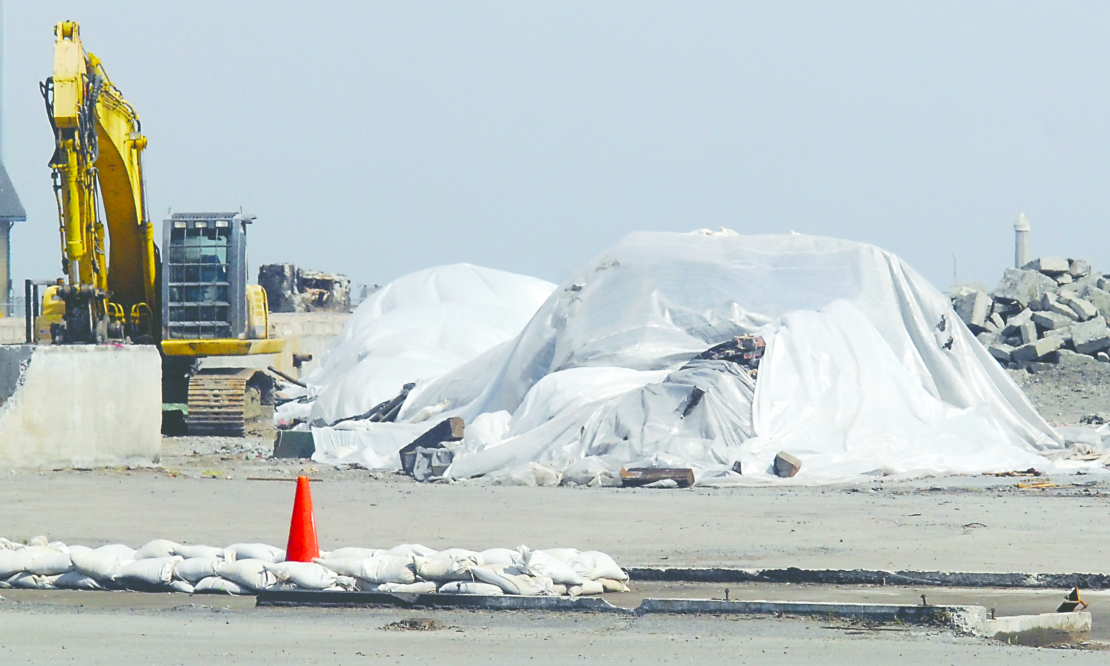 The remains of the former Peninsula Plywood smokestack sit covered with plastic.  -- Photo by Keith Thorpe/Peninsula Daily News