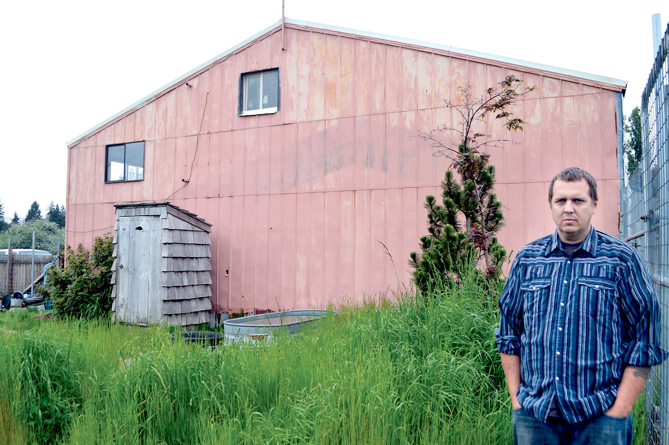 Steve Markwell stands in front of the Forks warehouse in which he once housed 124 dogs as the Olympic Animal Sanctuary.  —Photo by Joe Smillie/Peninsula Daily News. [Copyright &Copy; 2014