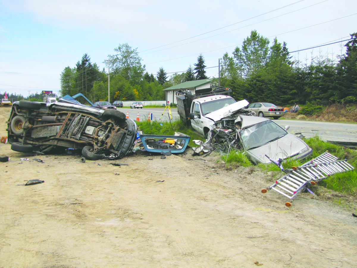 The three vehicles involved in Monday morning's fatal crash sit on the south side of U.S. Highway 101 near Dryke Road west of Sequim. Arwyn Rice/Peninsula Daily News