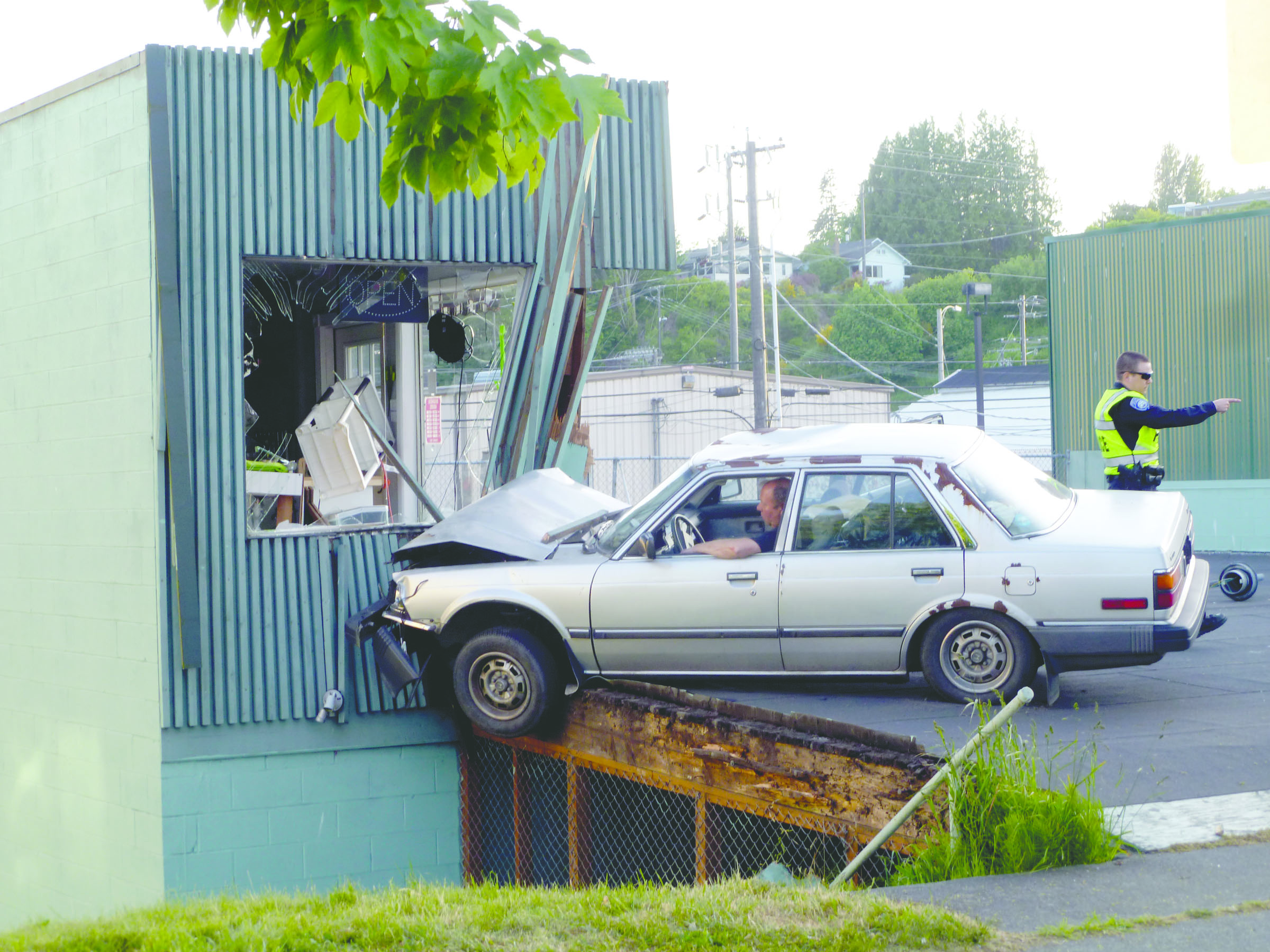 A 1987 Honda Accord driven by Howard Dale Gentry crashed into Energy 360 on First Street in Port Angeles on Tuesday. — Vivian Elvis Hansen/Peninsula Daily News